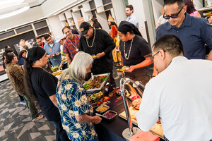 Chef Nephi serving bison to Simon Ortiz (pictured left in blue flowered shirt)