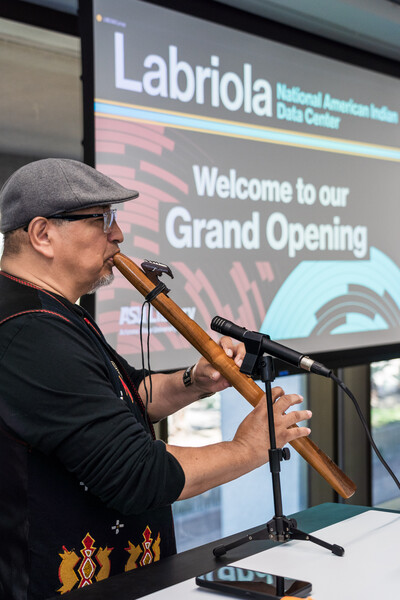Randy Kemp playing flute at Grand Opening luncheon