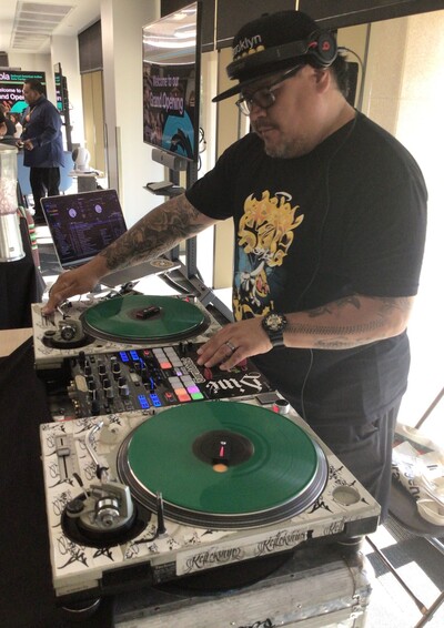 Deejay Reflekshin playing on his turntable at Grand Opening